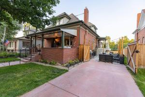 a brick house with benches in front of it at Historic Modern 6 Full Bath & 6 Bedrooms-near LoHi in Denver