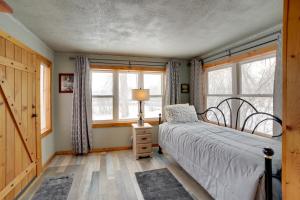 a bedroom with a bed and two windows at Inviting Missouri River Vacation Rental 2 Mi Away in Great Falls