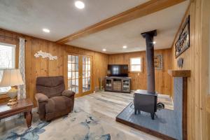 a living room with a fireplace and a chair at Inviting Missouri River Vacation Rental 2 Mi Away in Great Falls