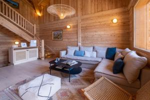 a living room with a couch and a table at Sublime Semi Detached Chalet Facing The Mont Blanc in Chamonix
