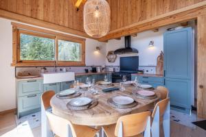 a kitchen with a wooden table and chairs at Sublime Semi Detached Chalet Facing The Mont Blanc in Chamonix