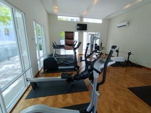 a gym with several tread machines in a room at 2Beds Seaview Straits Quay comes with Carpark and Hothub in Bagan Jermal