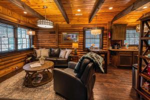 a living room with a couch and a table at Cozy Lakefront Cabin on Lake Nantahala with Dock in Topton