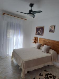 a bedroom with a bed and a ceiling fan at CASA ORIOL in Ayamonte