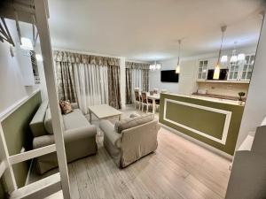 a living room and kitchen with a couch and a table at Sea angel in Burgas