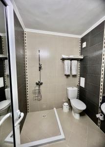 a bathroom with a shower and a toilet and a sink at Sea angel in Burgas