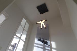 
a clock hanging from the ceiling in a room at MAFF Top Apartment in The Hague
