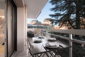 a dining table on the balcony of a house at CASABLANCA free parking in Annecy