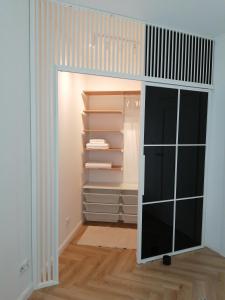 a walk in closet with a glass door at Gdańsk Porto Apartments in Gdańsk