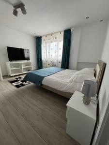 a bedroom with a bed and a flat screen tv at Karlsburg Studio in Alba Iulia