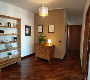 a hallway with a dresser and a lamp on a wooden floor at Bethel luxury fiumicino in Fiumicino
