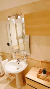 a bathroom with a sink and a mirror at Bethel luxury fiumicino in Fiumicino