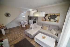 a living room with a couch and a table at Gold Gondola Premium Apartments in Ribnica