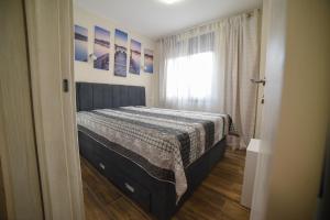 a bedroom with a bed and a window in a room at Gold Gondola Premium Apartments in Ribnica