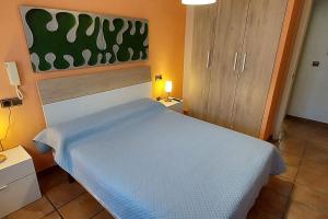 Schlafzimmer mit einem Bett mit blauer Tagesdecke in der Unterkunft Casa Joaquín en Gran Alacant in Gran Alacant