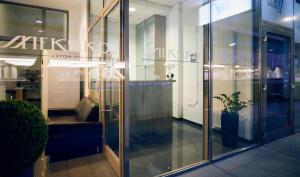 a glass door of a store with a potted plant at Hotel Meksiko in Ljubljana