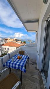 a table on a balcony with a view of the ocean at Studio Bellos in Tolo