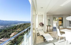 a dining room with a balcony with a table and chairs at Villa Pacifica in Santa Cristina d'Aro