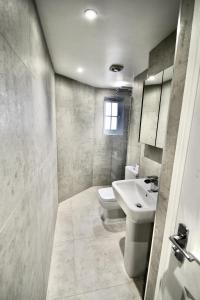 łazienka z białą umywalką i toaletą w obiekcie Mill House Townhouse w mieście Newmarket