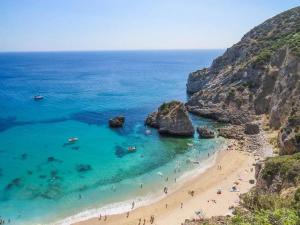 a view of a beach with people in the water at Sesimbra Retreat by the Sea in Sesimbra