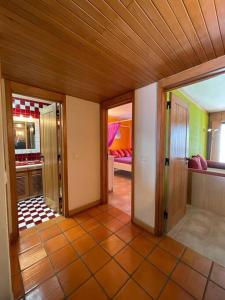 a room with a hallway with doors and a living room at Sesimbra Retreat by the Sea in Sesimbra