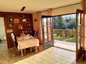 a dining room with a table and a sliding glass door at CasaVitis Erholung am Weinberg in Lontzen