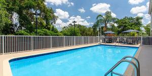 a large blue swimming pool with a fence at Holiday Inn Express Silver Springs - Ocala, an IHG Hotel in Silver Springs