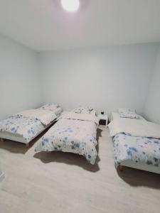 grupa czterech łóżek siedzących w pokoju w obiekcie Appartement proche St denis "appart 3" w mieście Pierrefitte-sur-Seine