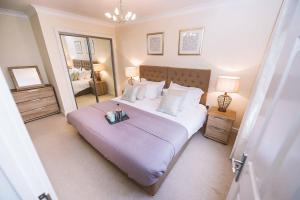 a bedroom with a large bed and a large mirror at ! LARGE ! Apartment Central Leatherhead Sleeps 6! in Leatherhead