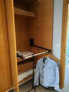 a shirt hanging on a rack in a room at Aparthotel El Faro in Cullera