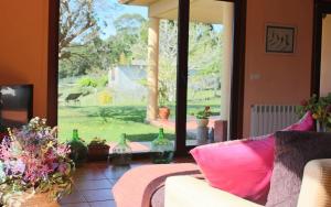 a living room with a couch and a large window at Espectacular casa a dos minutos de Playa America in Nigrán