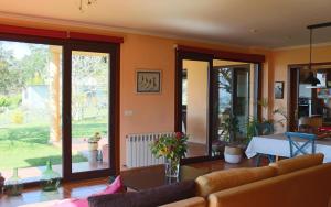 a living room with a couch and a table at Espectacular casa a dos minutos de Playa America in Nigrán +35 photos