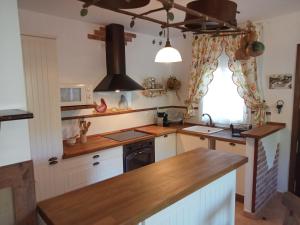 a kitchen with white cabinets and a counter top at Casa Estacion de Benaojan in Benaoján