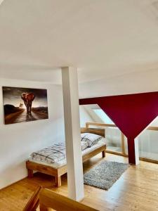 a room with two beds and a staircase with a picture on the wall at Wanderurlaub mit und ohne Hund! in Harra