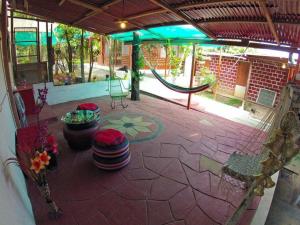 an outdoor patio with a swing set in a building at Casita Grau 2! Naturaleza y confort con Agua caliente,cocina y frigobar in Tarapoto