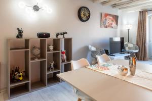 a dining room with a table and chairs and a desk at FITZ ROY Annecy Rent Lodge in Annecy