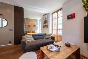 a living room with a couch and a table at ANNAPURNA Annecy Rent Lodge in Annecy