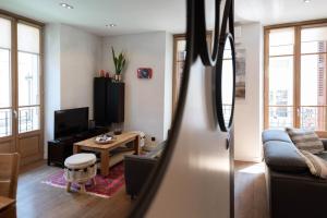 a living room with a couch and a table at ANNAPURNA Annecy Rent Lodge in Annecy