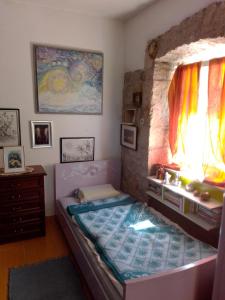 a bedroom with a large bed and a window at Apartman SIRENA in Pićan