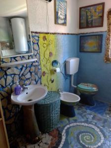 a bathroom with a sink and a toilet at Apartman SIRENA in Pićan