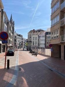 an empty street in a city with buildings at ERNA in Blankenberge