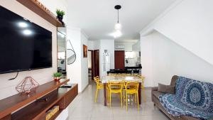 a living room with a couch and a dining room at Conforto para Famílias e Idosos no Térreo in Porto Seguro