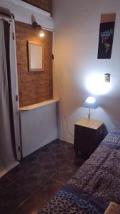 pokój z łóżkiem i lampką na stole w obiekcie Monoambiente interno en Trelew w mieście Trelew