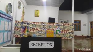 a room with a podium with a sign that says reception at Orzu Guest House in Bukhara