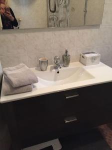 a bathroom sink with a towel and a mirror at Casa Orchidea in Oria