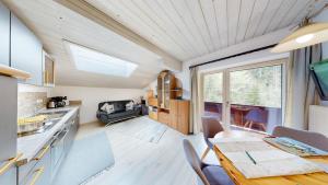 a kitchen and dining room of a tiny house at Das Panoramablick in Lofer