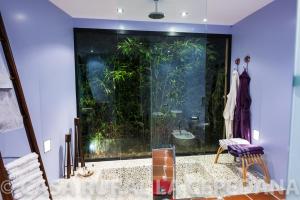 an aquarium in the corner of a room with a glass wall at Descubre La Cepedana: Casa rural con encanto en Cogorderos, a solo 10 km de Astorga in Cogorderos +37 photos