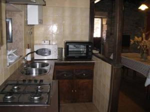 a small kitchen with a sink and a microwave at camino de santiago in Forcarei