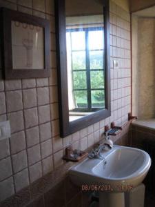 a bathroom with a sink and a mirror and a window at camino de santiago in Forcarei