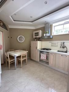 a kitchen with a table and a stove top oven at Esclusiva Luxury Villa con giardino in Ischia